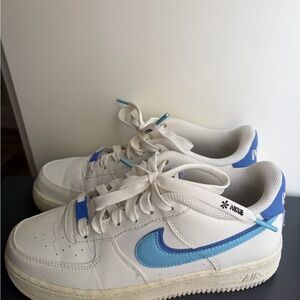Nike White Low-Top Sneakers with Blue and Light Blue Swoosh